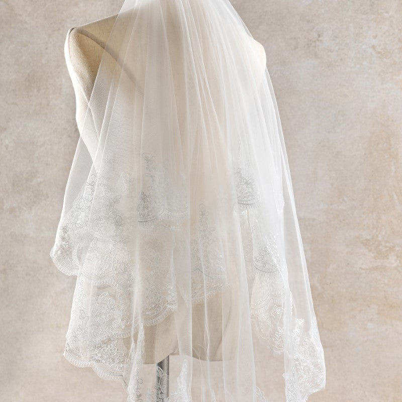 White lace veil on a neutral background