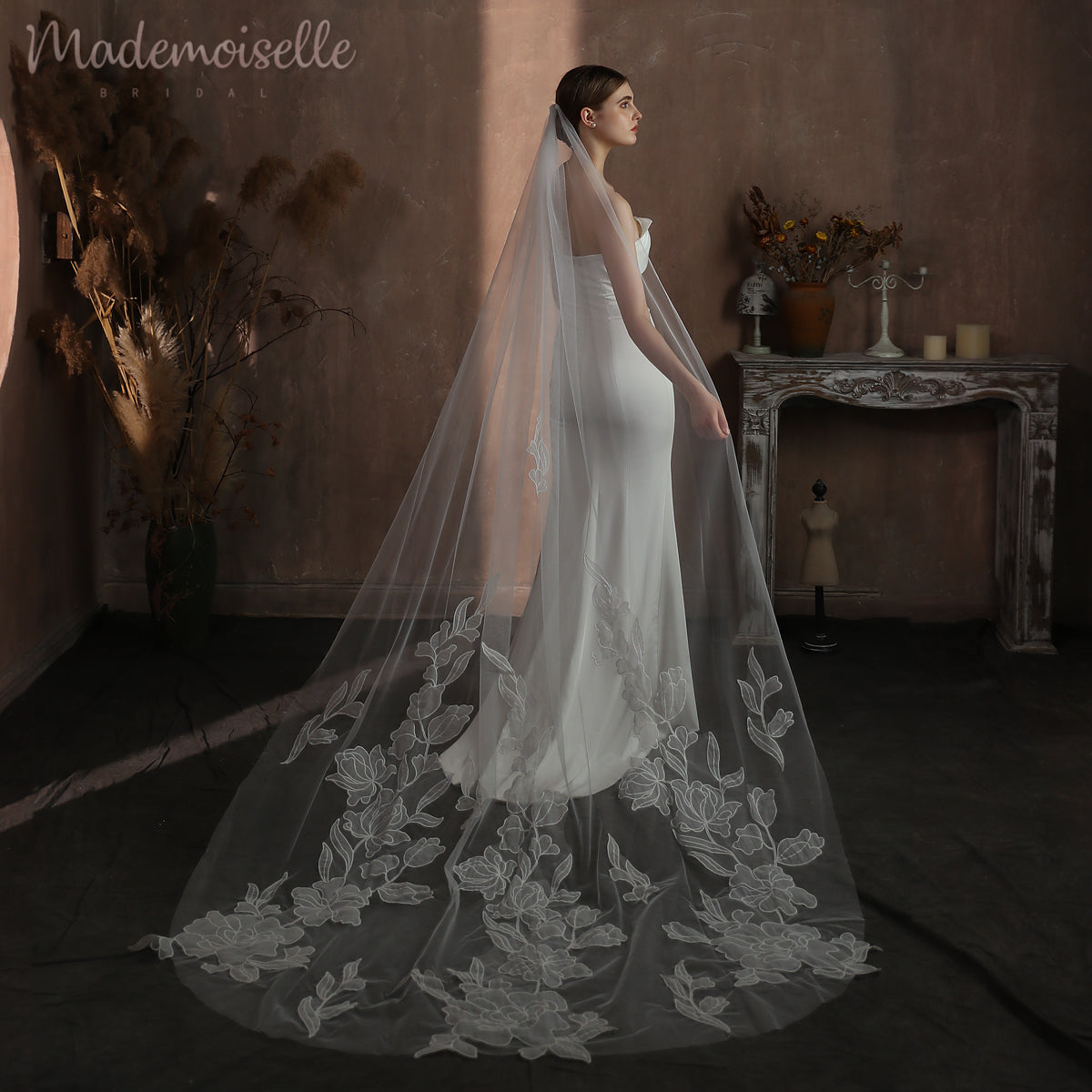 The bride's exquisite long veil, embellished with delicate floral pattern lace, enhances her beauty and charm on her wedding day.