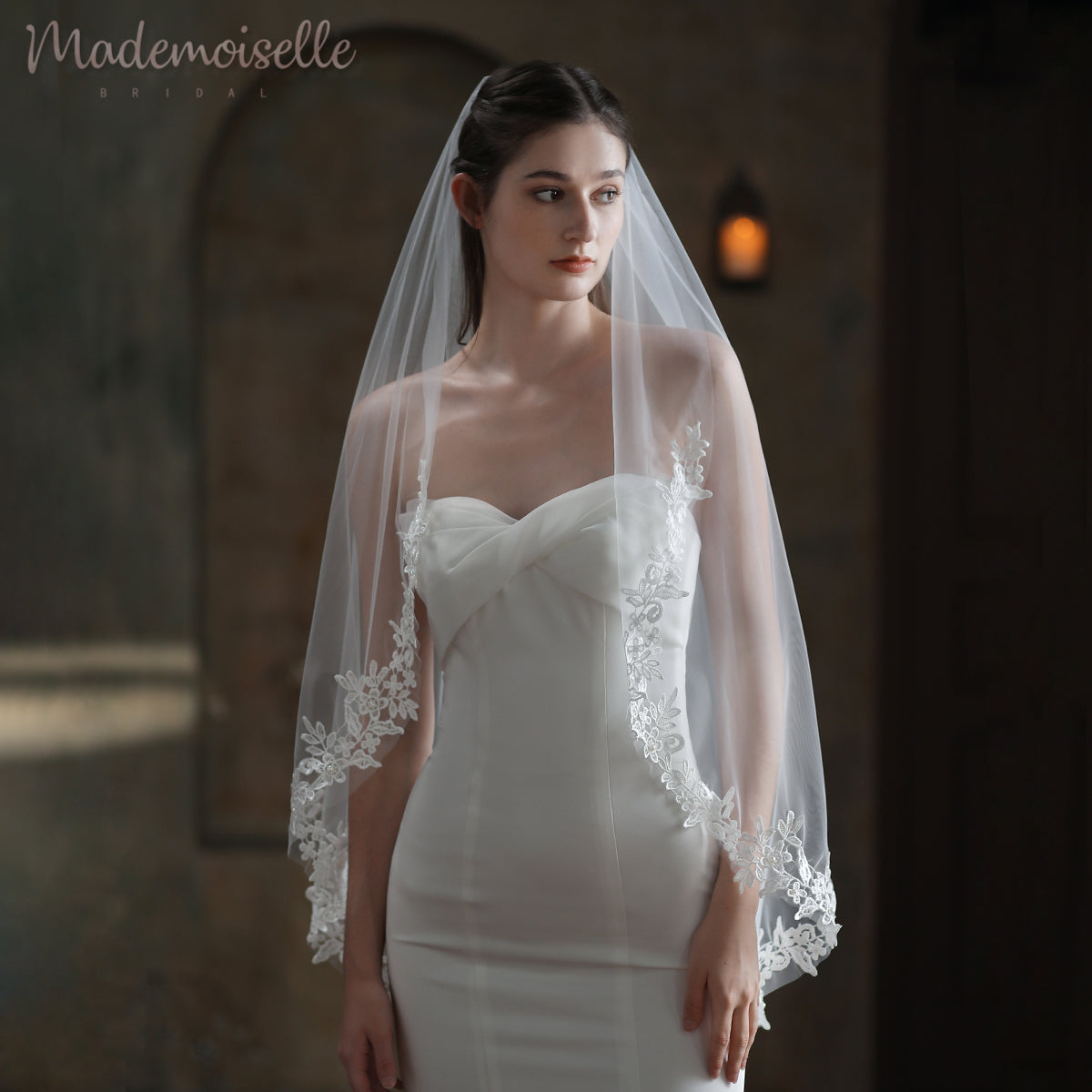 A radiant bride in a stunning white wedding dress, gracefully adorned with a delicate veil with lace edge, exuding elegance and joy.
