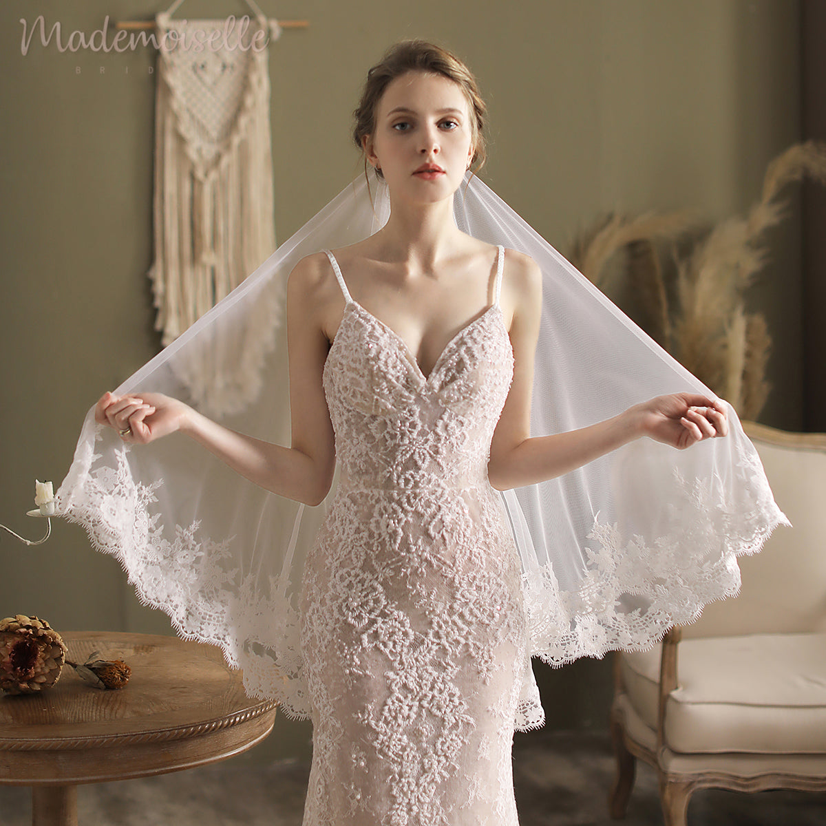 A breathtaking bride in a wedding dress, elegantly topped with a beautiful veil with a lace appliqué edge