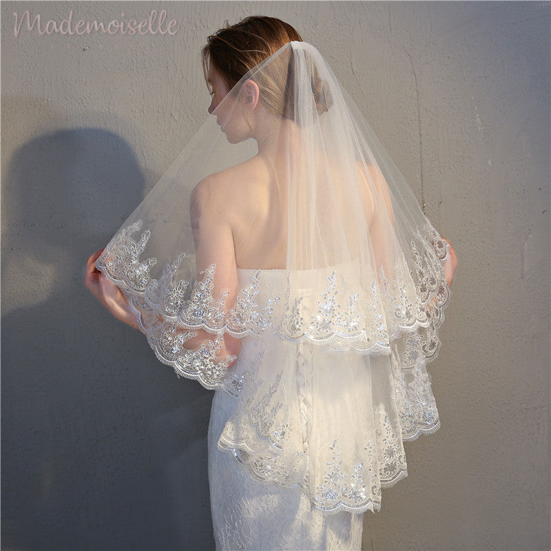 The back view of a woman in a wedding veil, capturing the essence of romance and the anticipation of her wedding ceremony.