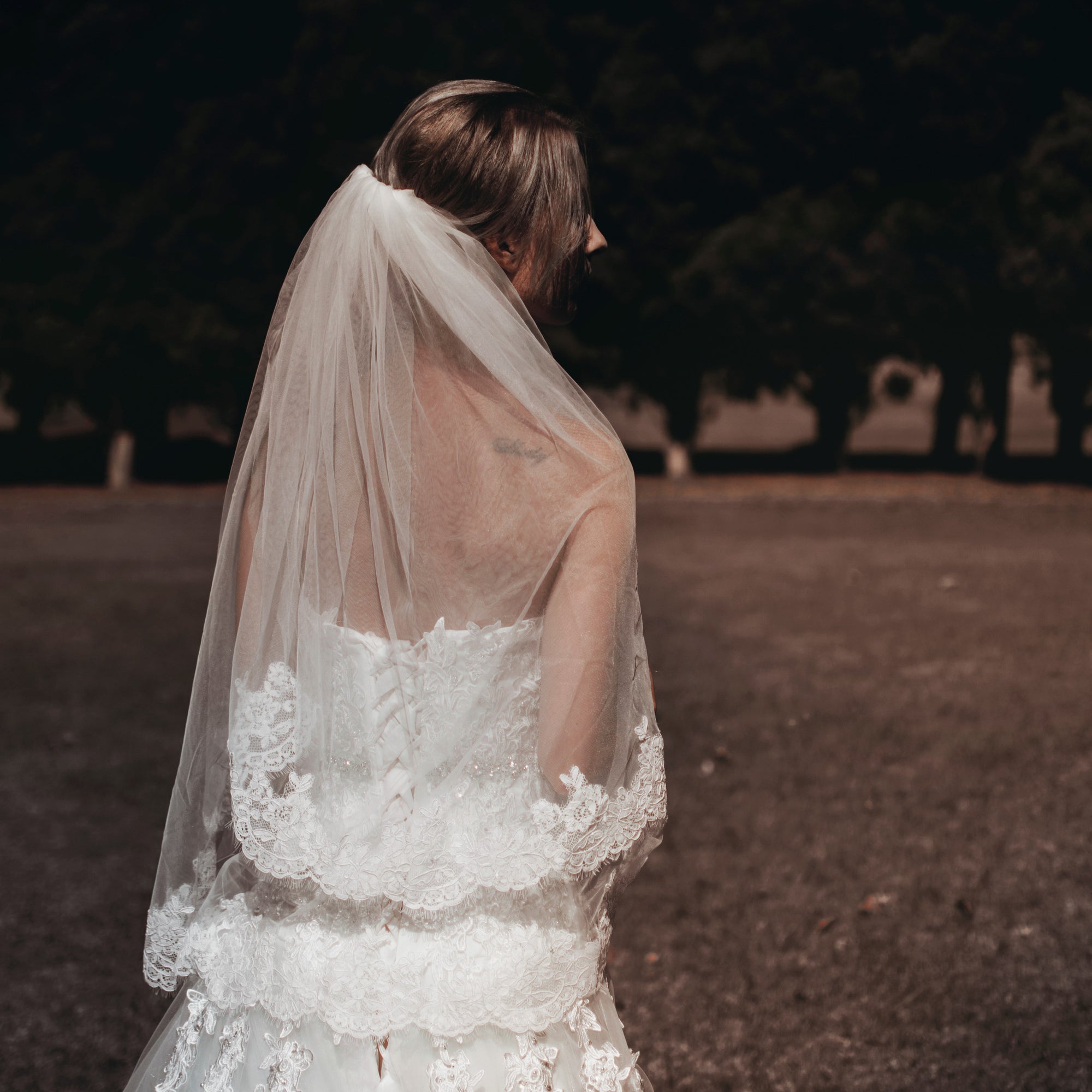 A lovely bride in a flowing wedding dress and veil, capturing the essence of romance and celebration on her big day.