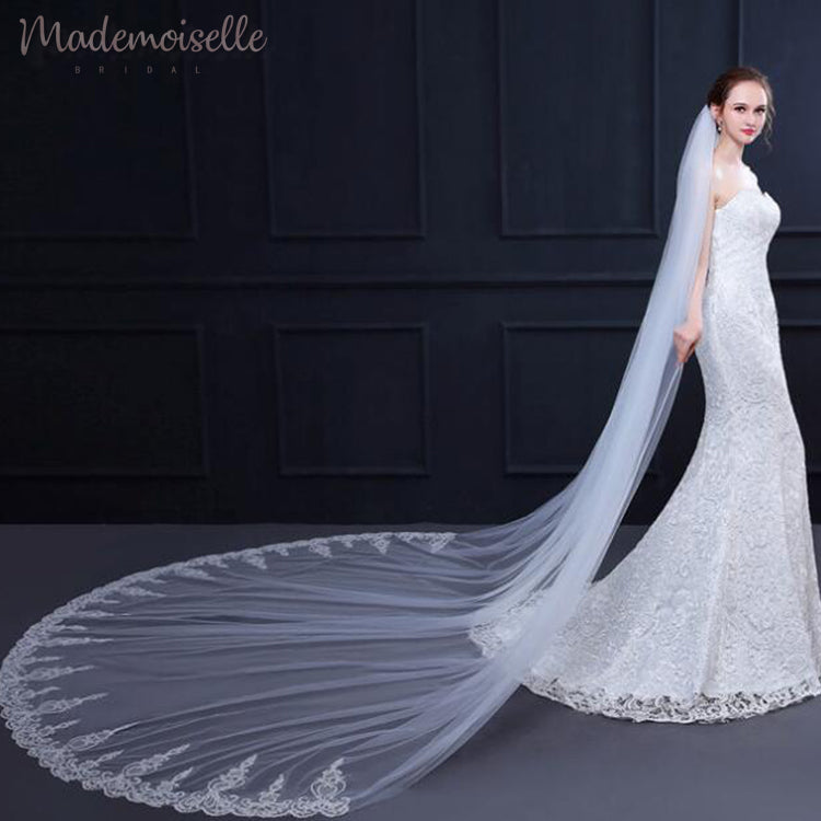 A stunning lace wedding veil with an elegant long train, perfect for a beautiful bridal look.